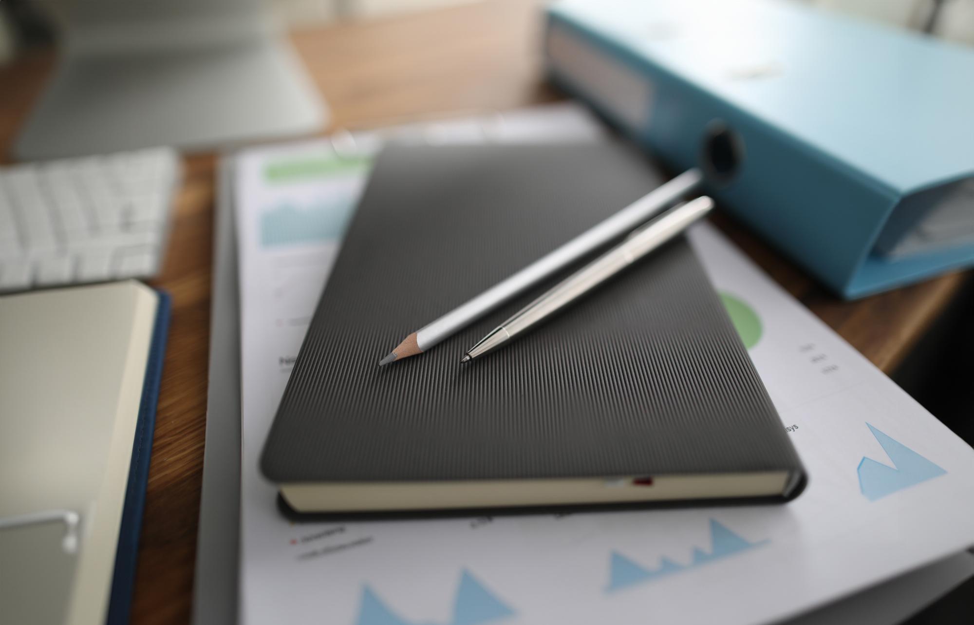 Close-up of planner with finance notes and pen